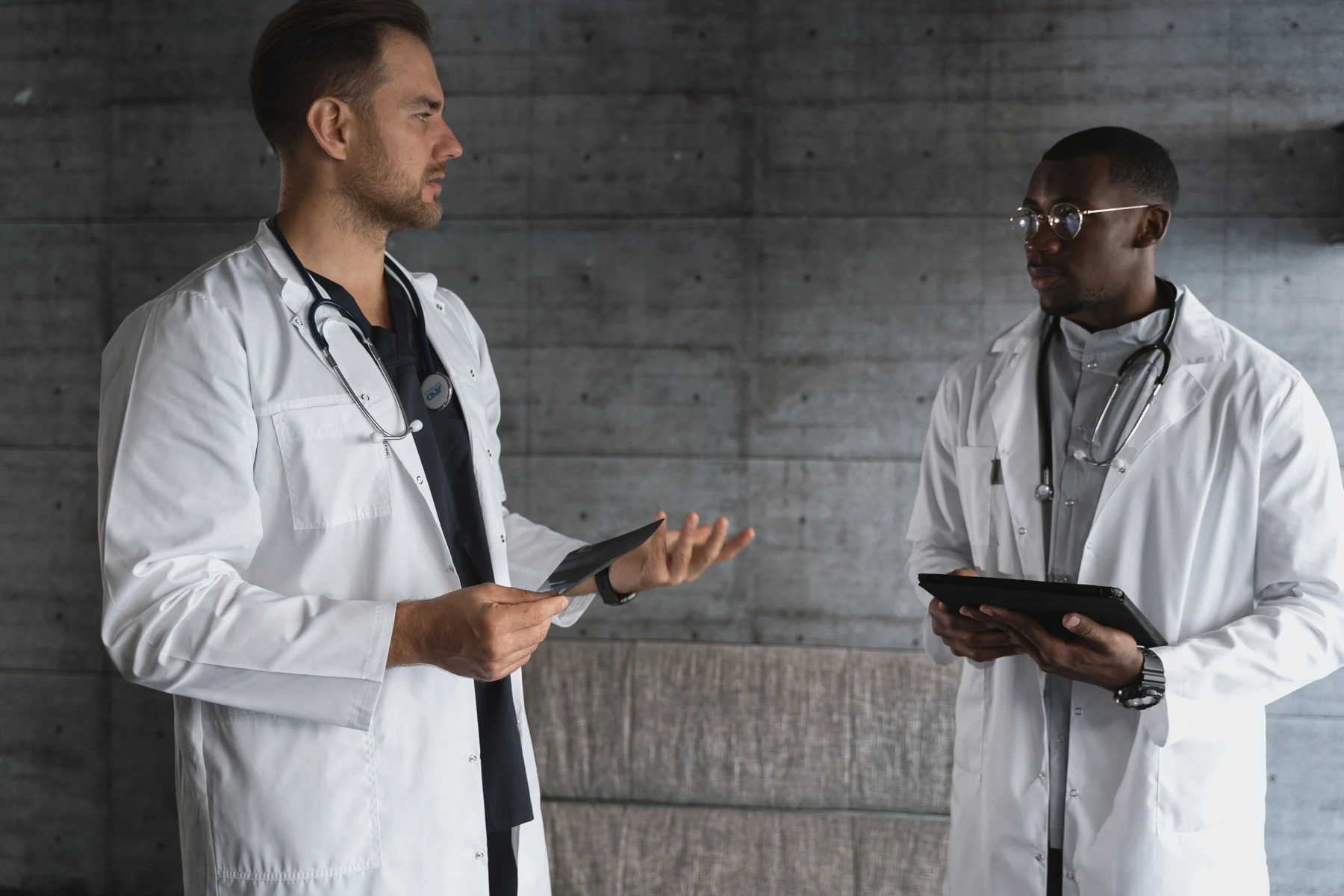 Doctors discussing clinical research using tablets