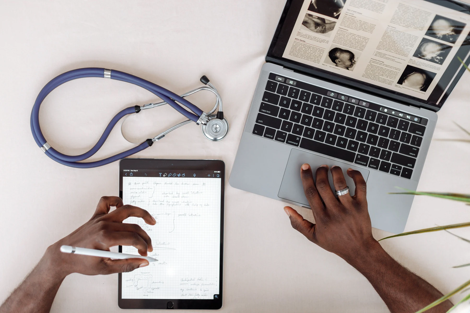 Medical research workspace with a laptop and notes